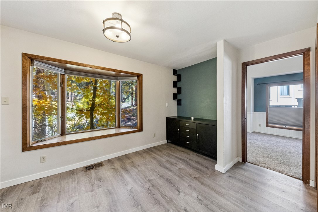 908 Harold Drive, Unit 23 Incline Village, NV 89451 - Photo 12 of 44 a view of an empty room with wooden floor and a window