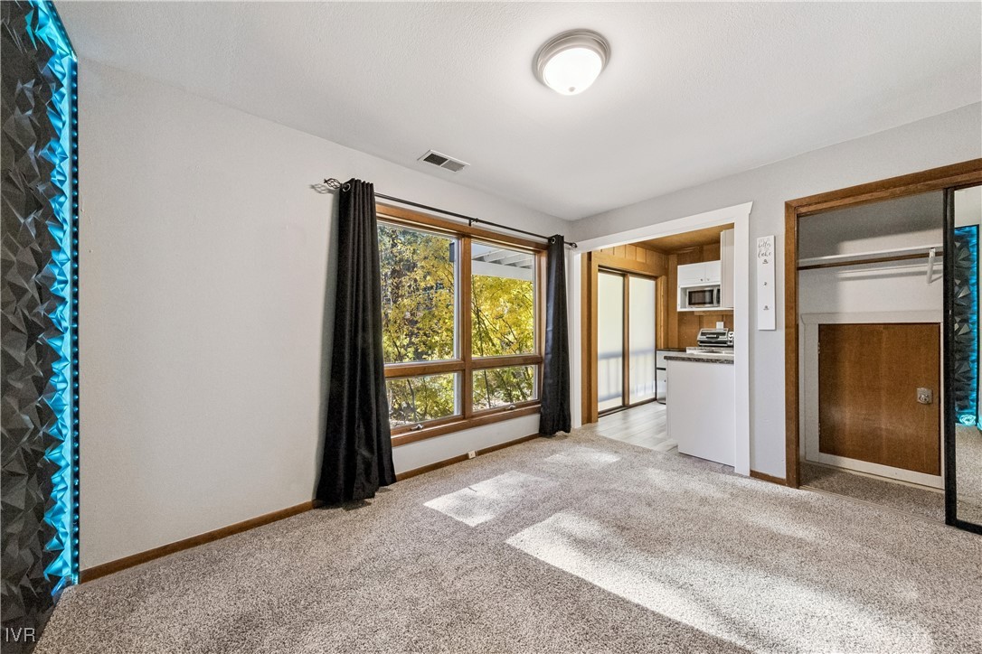 908 Harold Drive, Unit 23 Incline Village, NV 89451 - Photo 28 of 44 an empty room with windows and closet