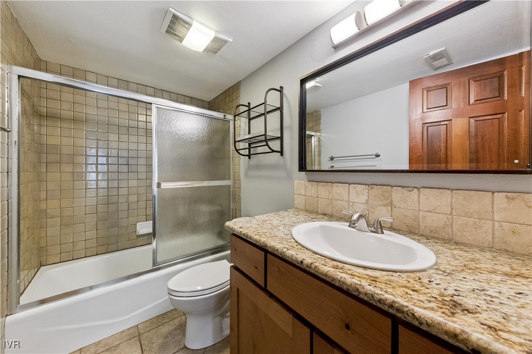 908 Harold Drive, Unit 23 Incline Village, NV 89451 - Photo 32 of 44 a bathroom with a granite countertop sink toilet and shower