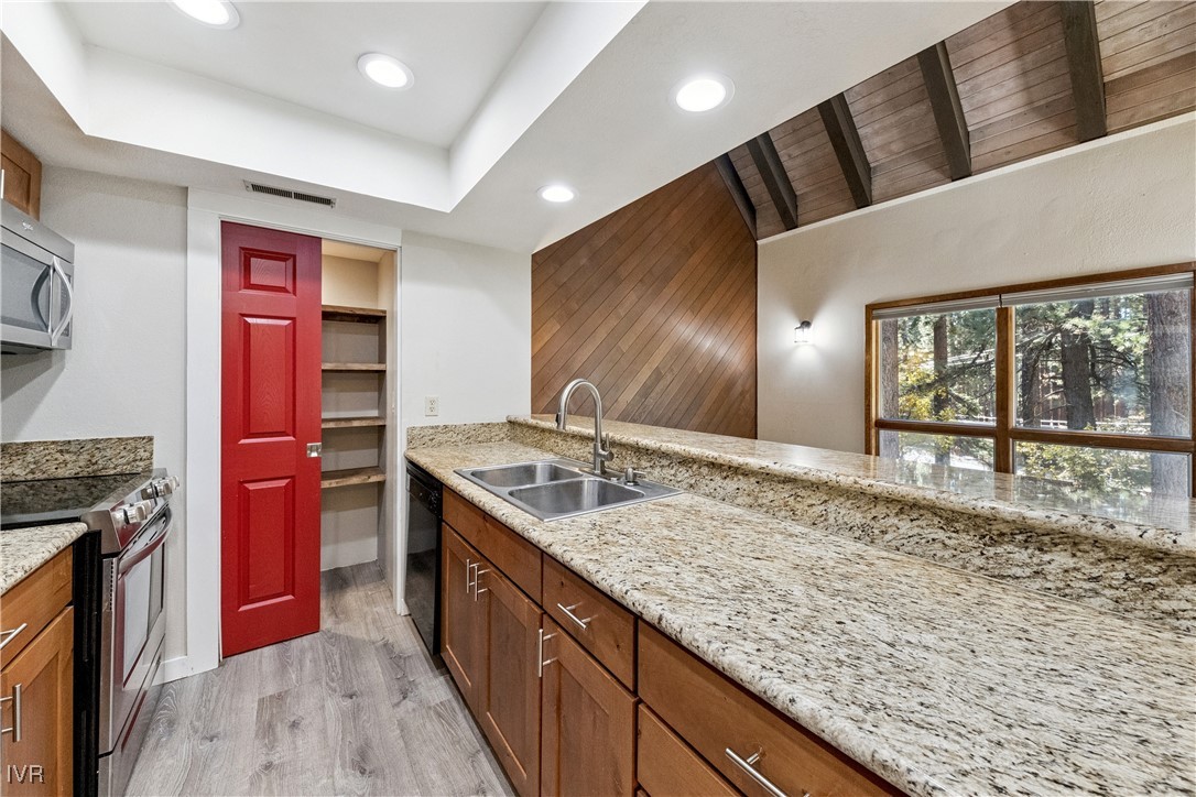 908 Harold Drive, Unit 23 Incline Village, NV 89451 - Photo 4 of 44 a kitchen with stainless steel appliances granite countertop a sink and a wooden cabinets