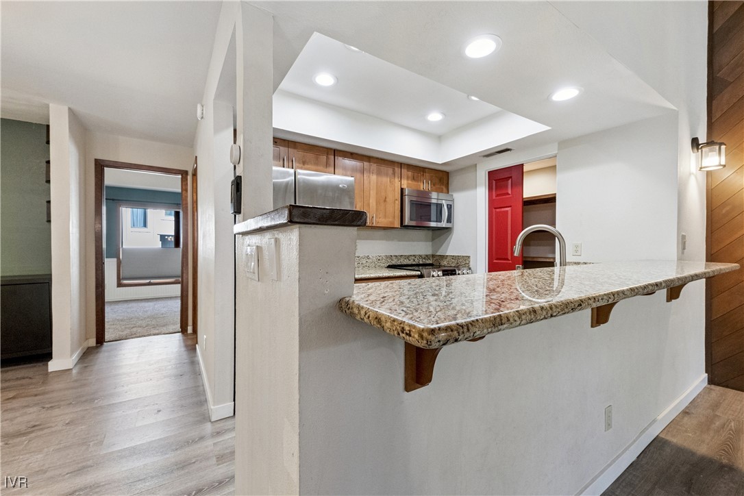 908 Harold Drive, Unit 23 Incline Village, NV 89451 - Photo 7 of 44 a kitchen with stainless steel appliances granite countertop a sink refrigerator and microwave