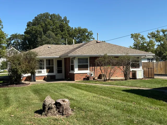 a view of a house with garden and yard
