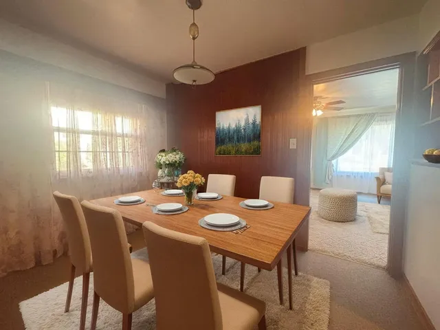 a view of a dining room with furniture a chandelier and wooden floor