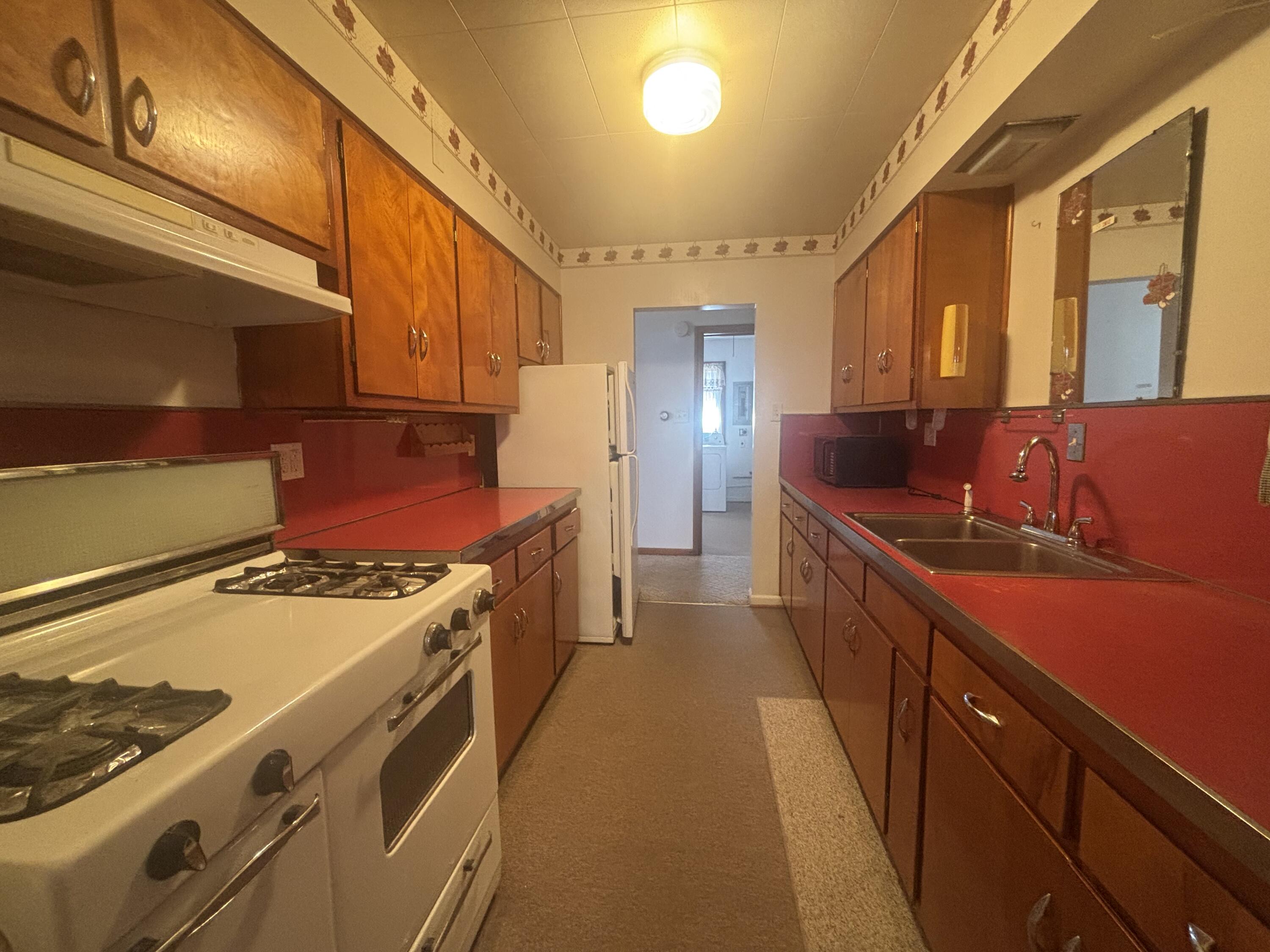 402 South Home Avenue Rensselaer, IN 47978 - Photo 7 of 27 a kitchen with stainless steel appliances granite countertop a stove and a sink