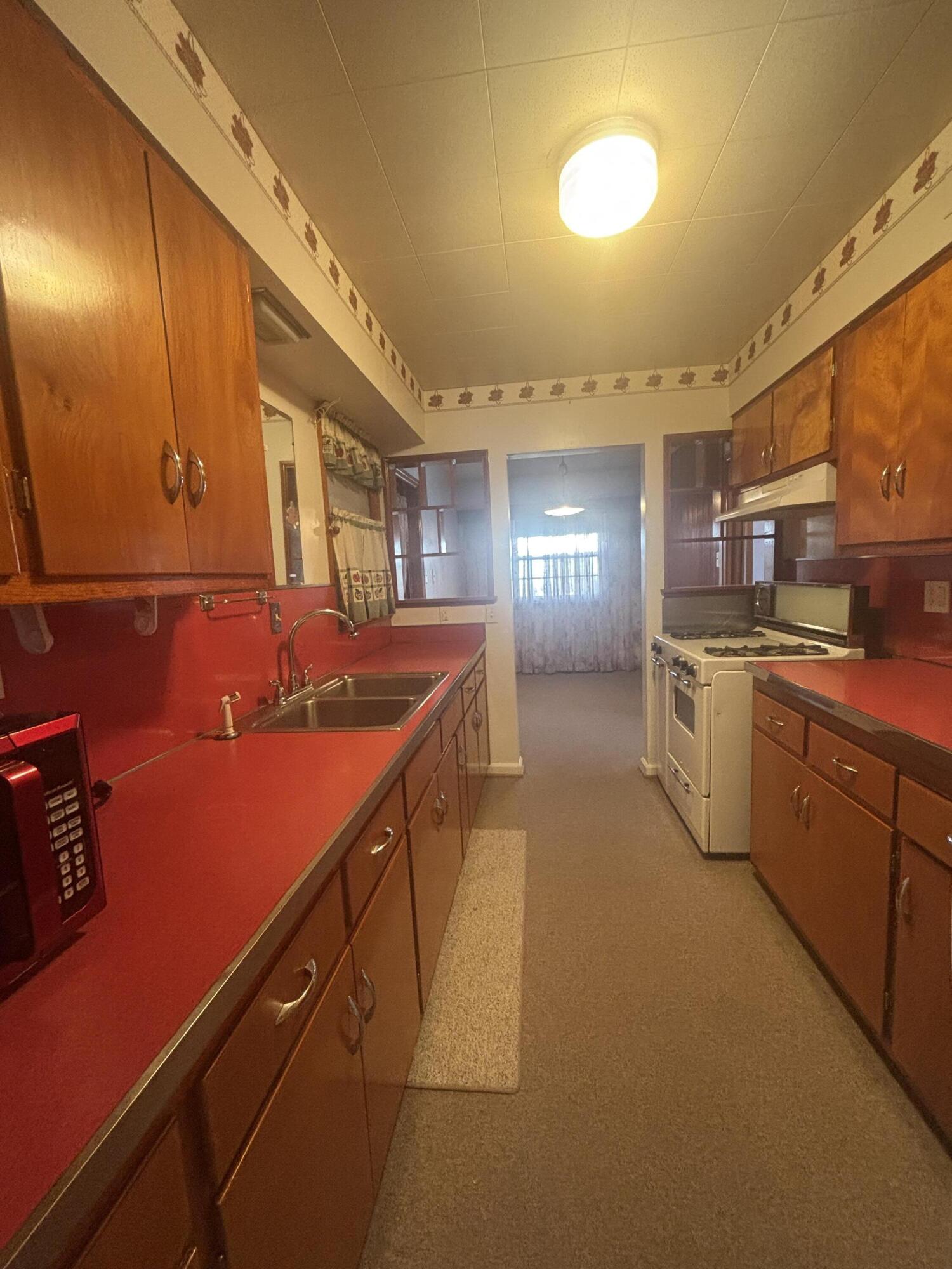 402 South Home Avenue Rensselaer, IN 47978 - Photo 8 of 27 a kitchen with stainless steel appliances granite countertop a sink and cabinets