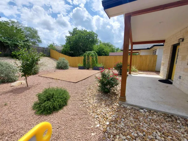 a view of a yard with potted plants