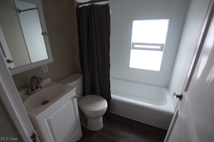 3606 Shelby Road Youngstown, OH 44511 - Photo 16 of 33 Full bathroom with toilet, hardwood / wood-style floors, oversized vanity, and shower / tub combo with curtain