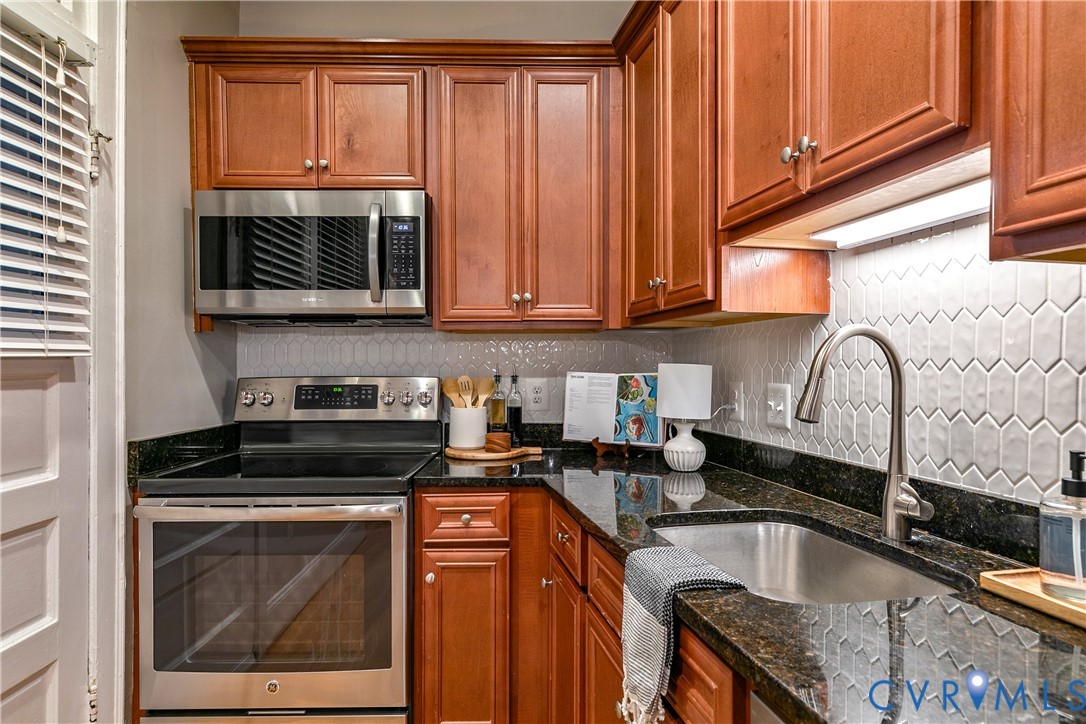 601 Roseneath Road, Unit U1 Richmond, VA 23221 - Photo 15 of 36 Kitchen featuring wood-finish cabinetry, dark ston