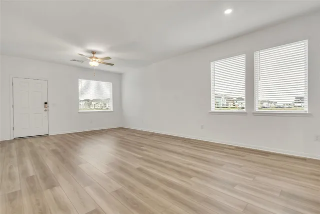 wooden floor in an empty room with a window