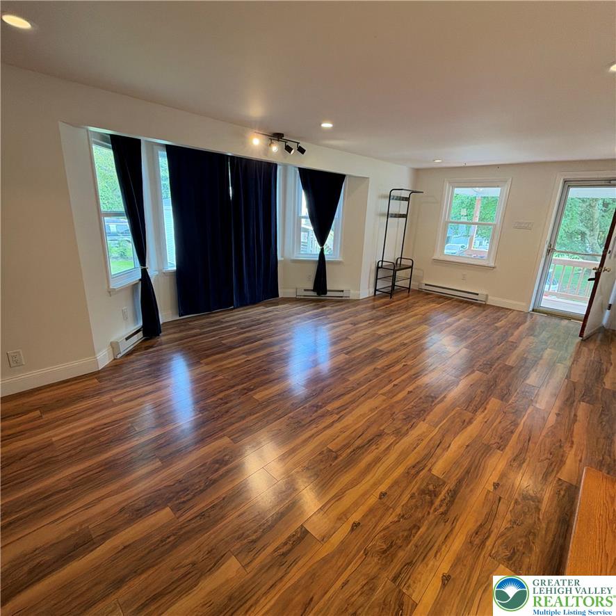 5111 Vera Cruz Road Emmaus, PA 18049 - Photo 23 of 44 Lustrous wood flooring pairs with recessed lighting across this versatile living area.