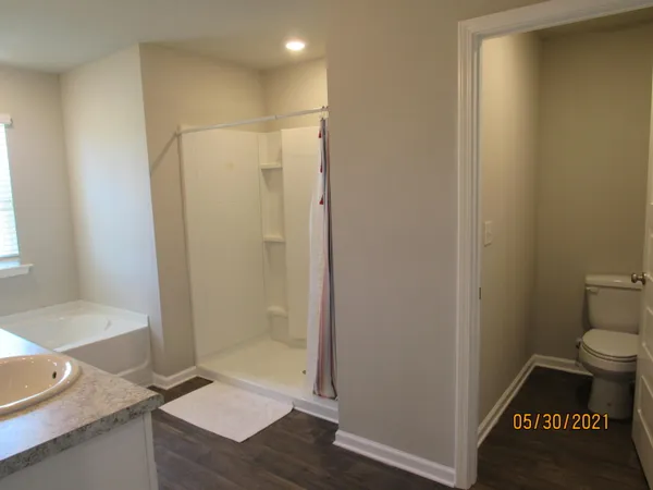 a bathroom with a granite countertop sink toilet and shower