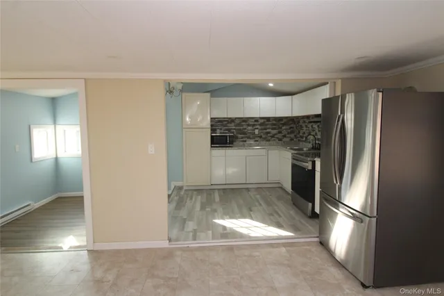 a kitchen with a refrigerator and a sink