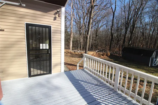 a view of a house with a wooden deck
