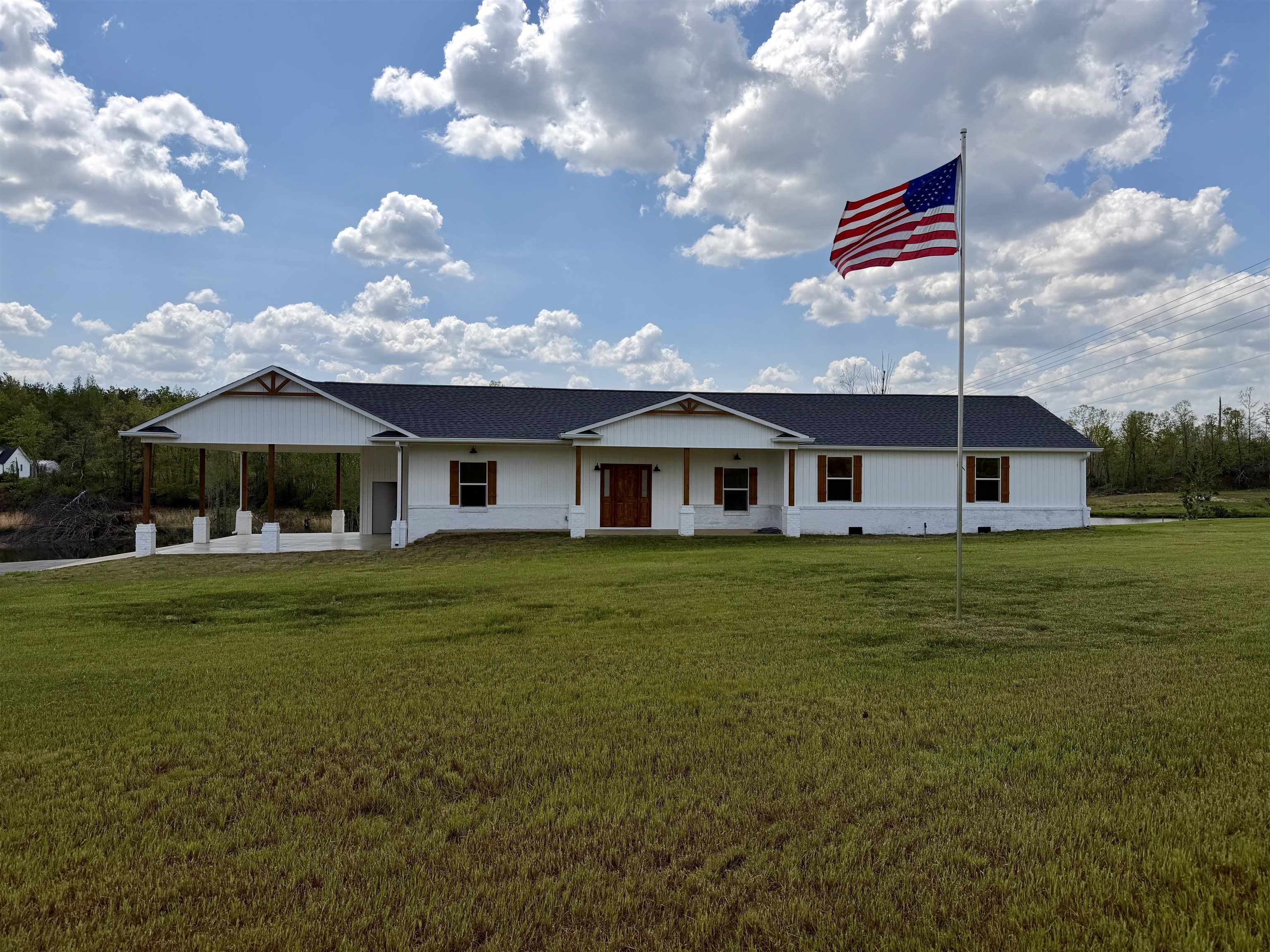 172 New Bethel Road Selmer, TN 38375 - Photo 1 of 30 a front view of a house with a garden