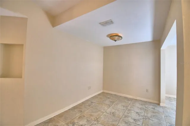 a view of a kitchen with a sink and a refrigerator