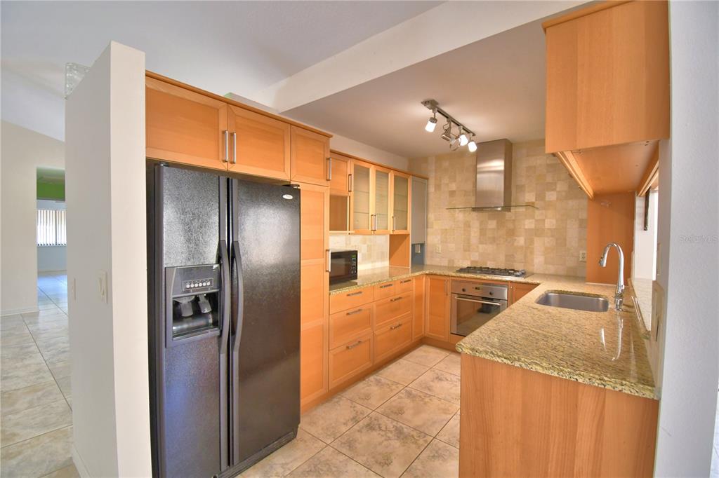 263 Mariposa Winter Haven, FL 33884 - Photo 15 of 69 a kitchen with a refrigerator a sink and cabinets