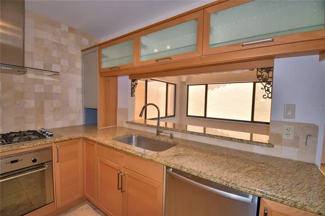 a bathroom with a granite countertop sink and a large mirror