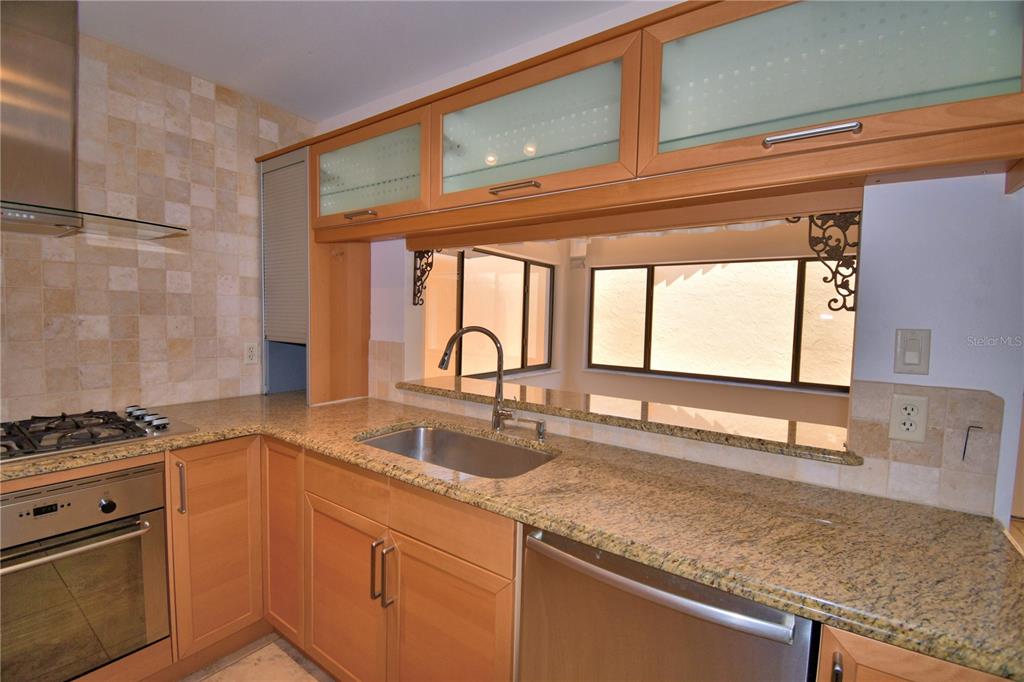 263 Mariposa Winter Haven, FL 33884 - Photo 17 of 69 a kitchen with granite countertop a sink and a window