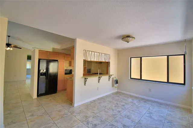 a view of an empty room with a ceiling fan