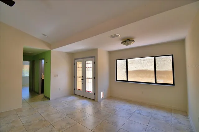 an empty room with windows and closet