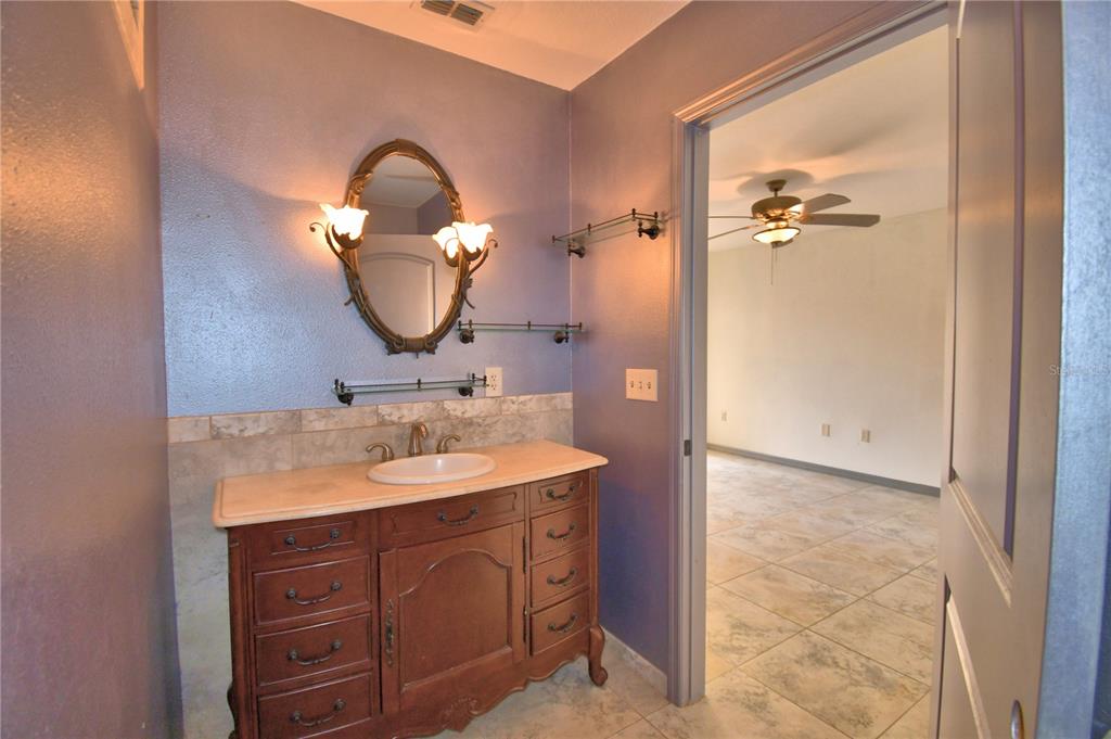 263 Mariposa Winter Haven, FL 33884 - Photo 39 of 69 a bathroom with a sink and a mirror