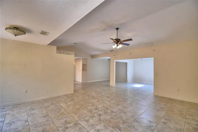 a view of a livingroom with a ceiling fan and window