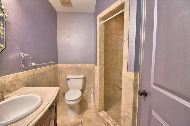 a view of a house with backyard and a tree