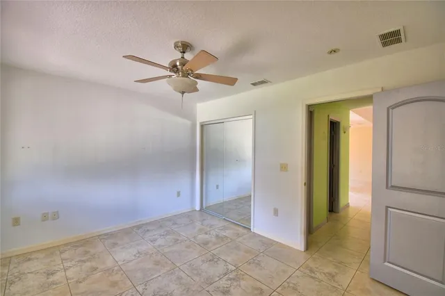 a front view of a house with a garden and trees