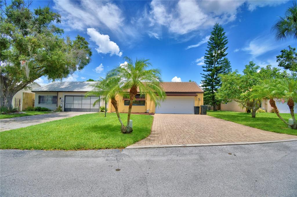 263 Mariposa Winter Haven, FL 33884 - Photo 68 of 69 a front view of a house with a garden and trees