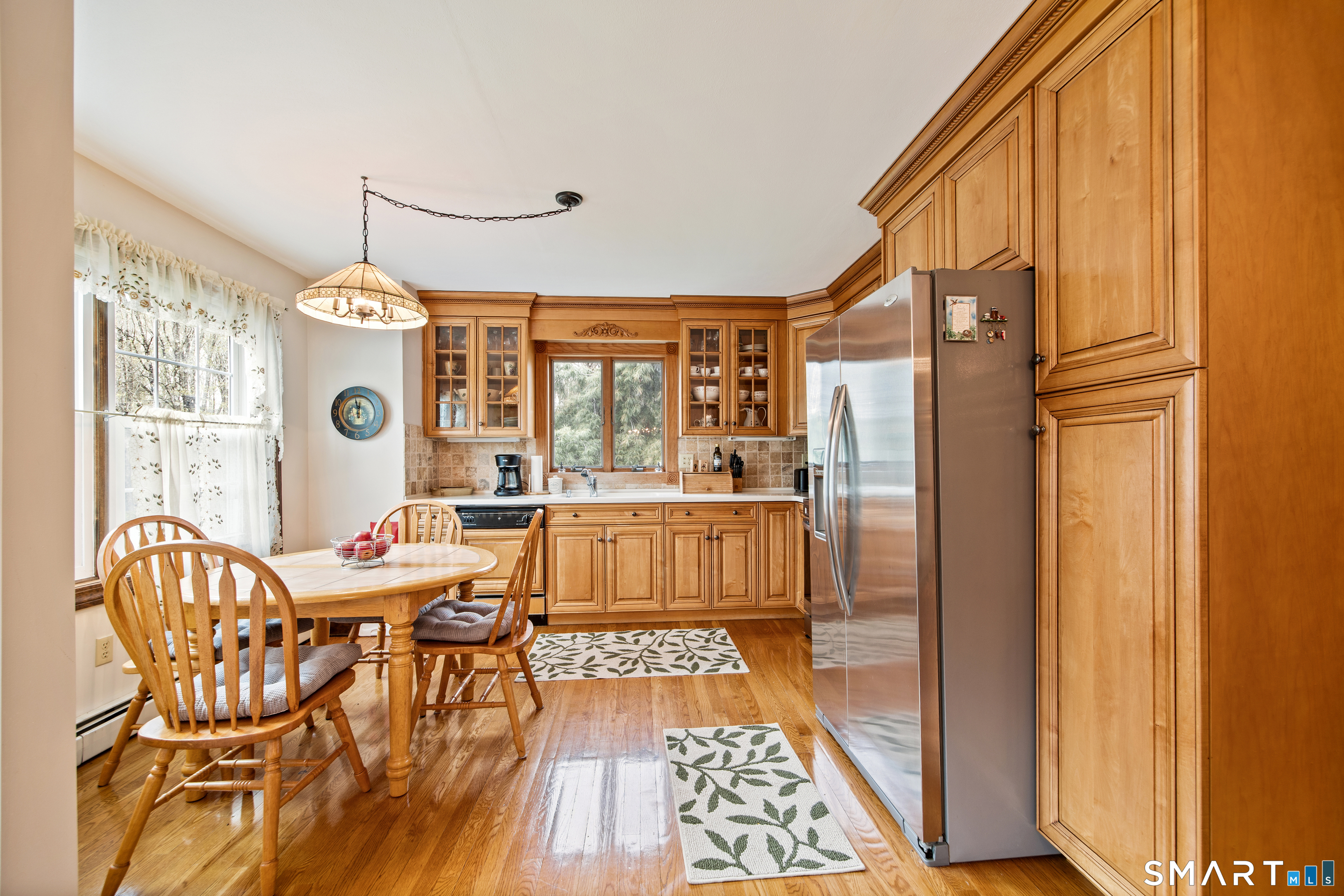 105 Quaker Farms Road Southbury, CT 06488 - Photo 11 of 40 a dining room with furniture a chandelier and wooden floor