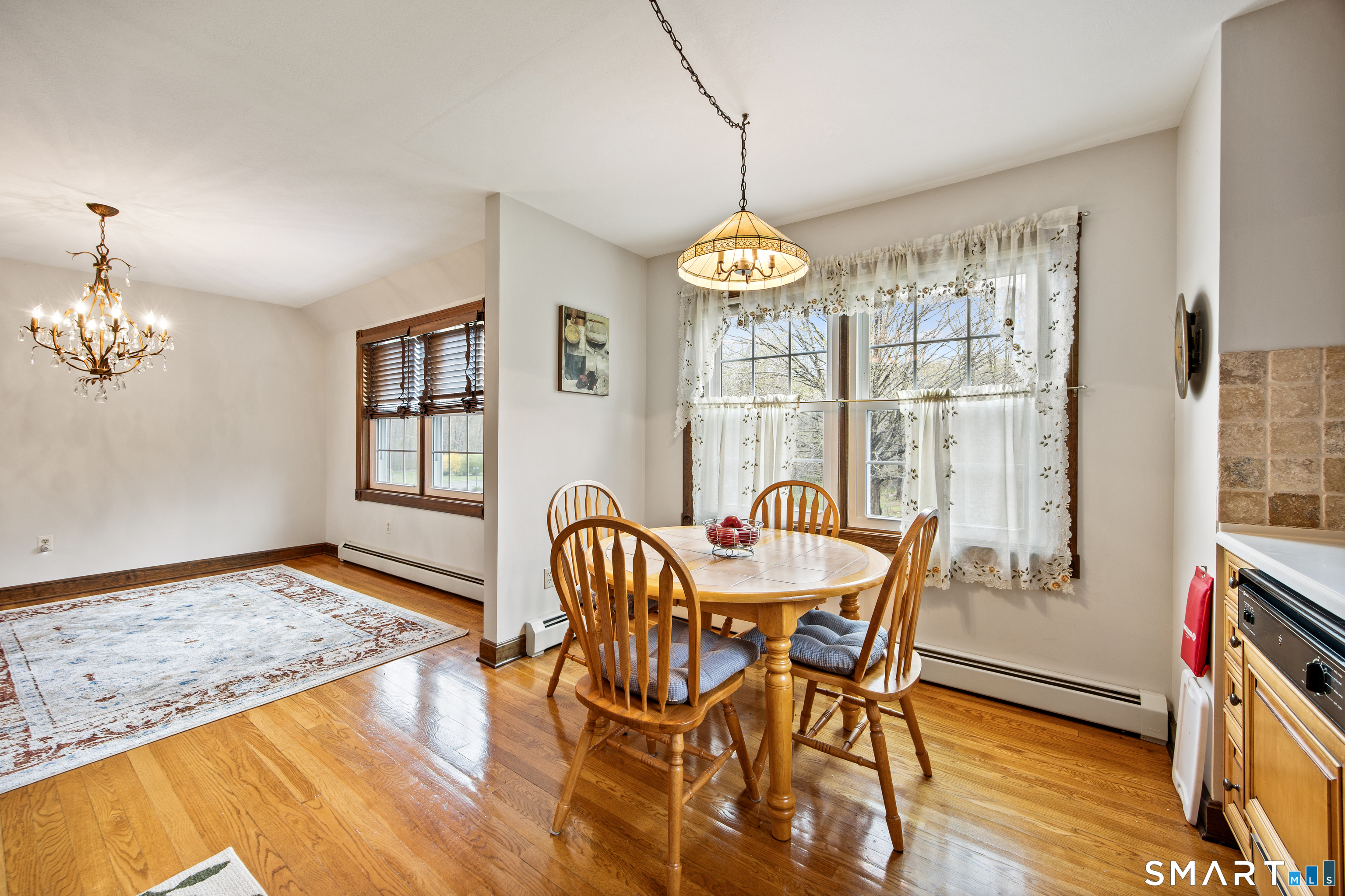 105 Quaker Farms Road Southbury, CT 06488 - Photo 13 of 40 a view of a dining room with furniture a chandelier and wooden floor
