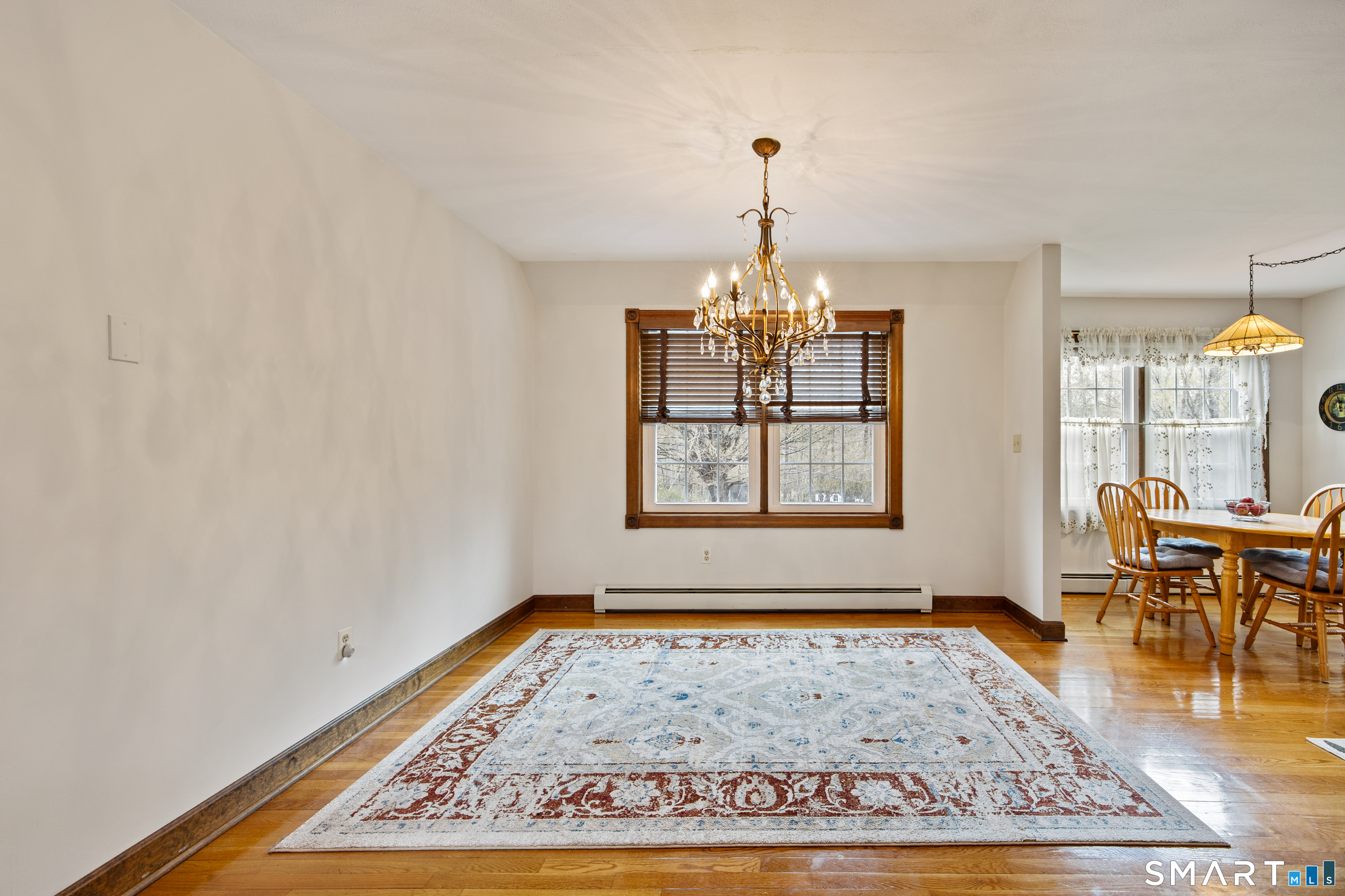 105 Quaker Farms Road Southbury, CT 06488 - Photo 14 of 40 an empty room with wooden floor windows and wooden floor