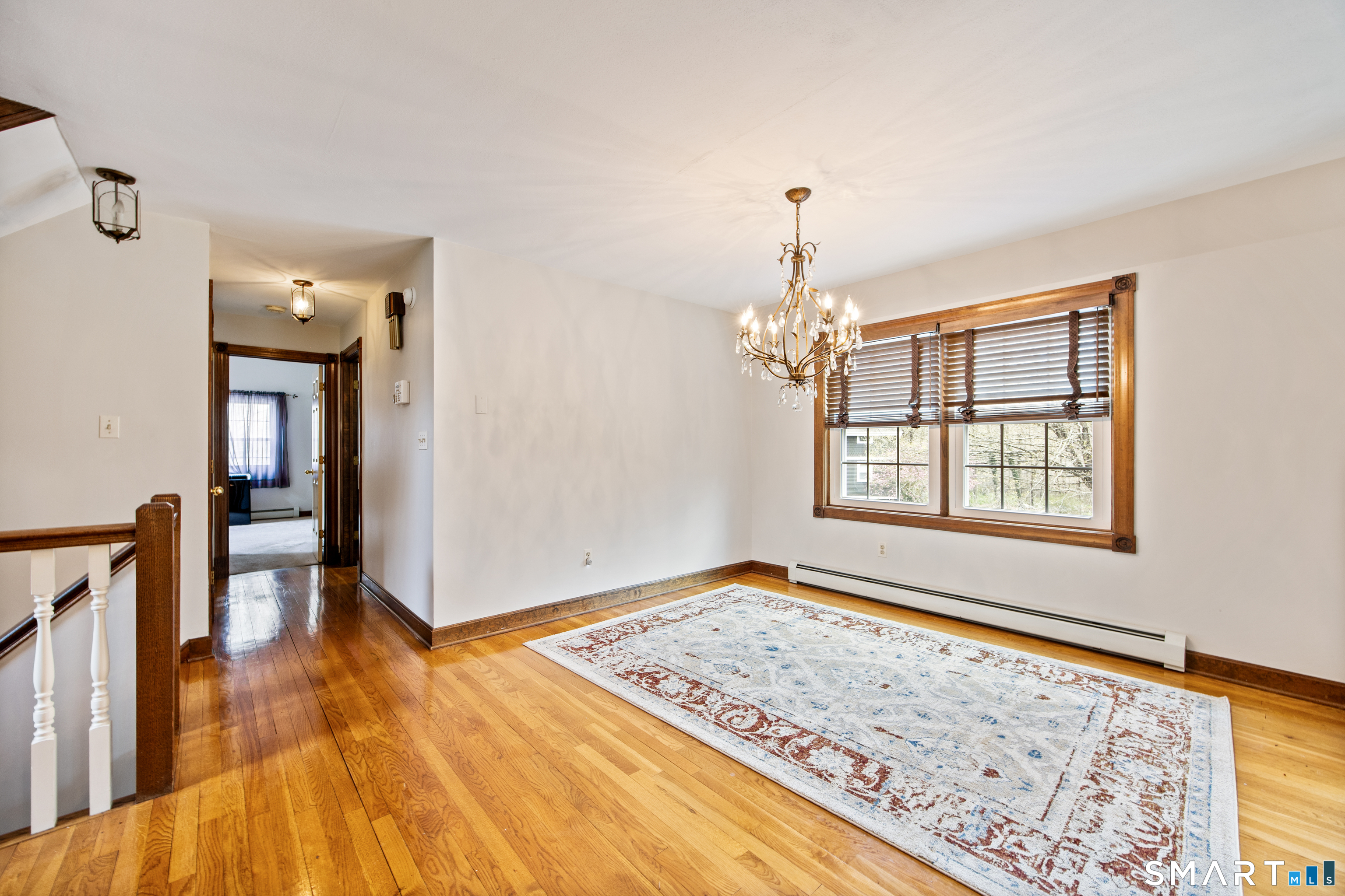105 Quaker Farms Road Southbury, CT 06488 - Photo 15 of 40 a view of an empty room with window and wooden floor
