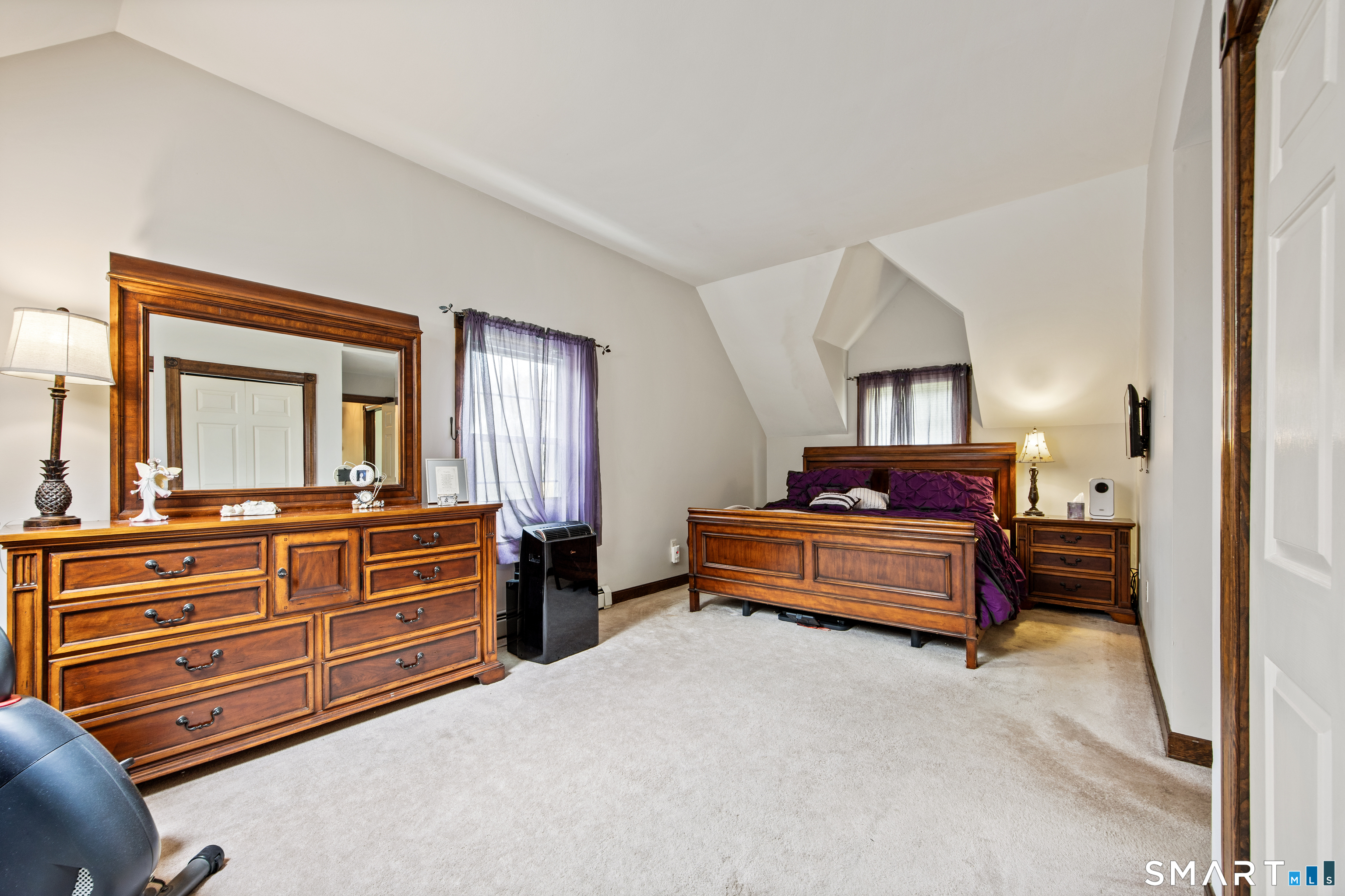 105 Quaker Farms Road Southbury, CT 06488 - Photo 17 of 40 a bedroom with a bed and wooden floor