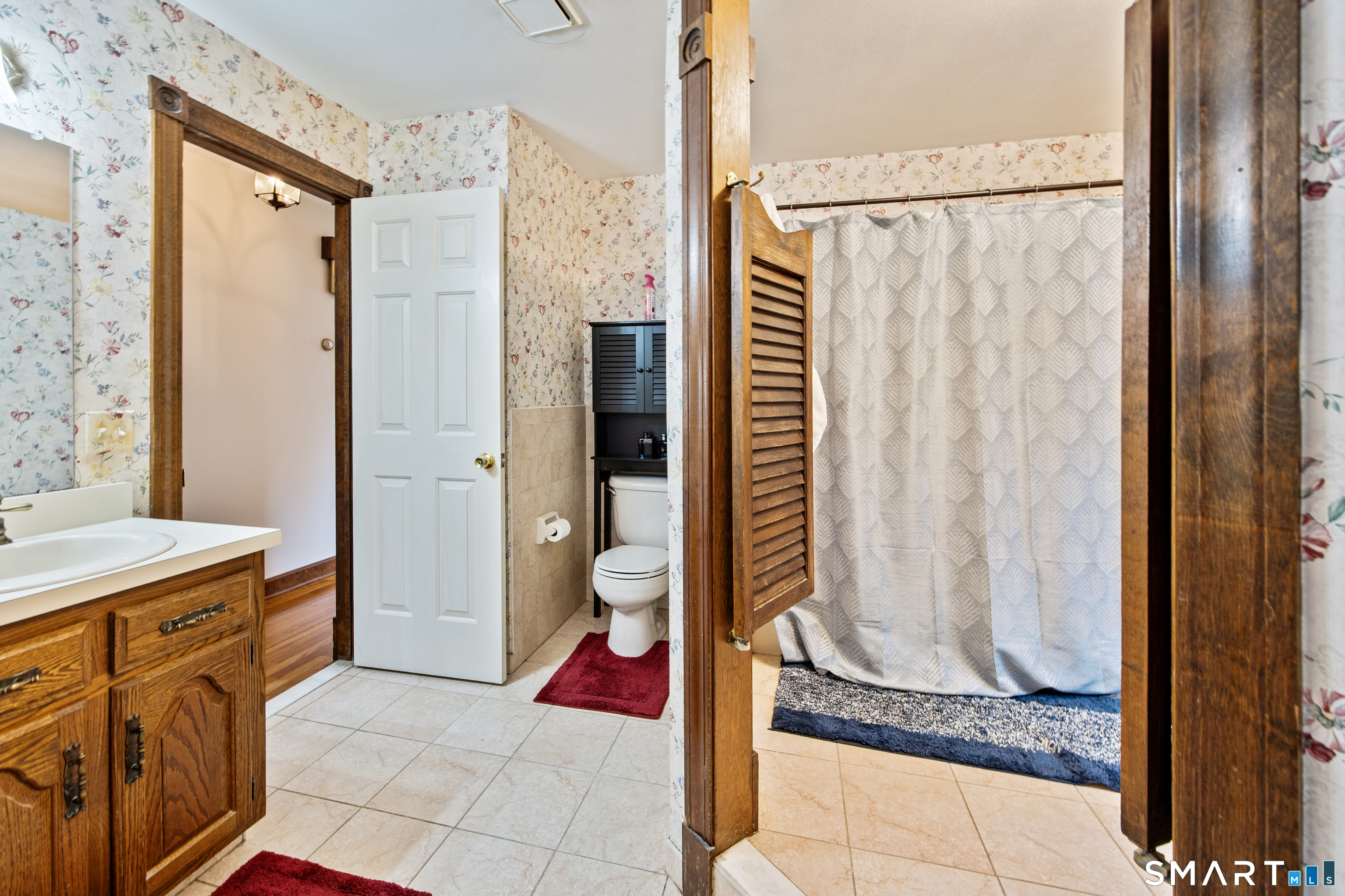 105 Quaker Farms Road Southbury, CT 06488 - Photo 19 of 40 a bathroom with a granite countertop shower a mirror and a sink