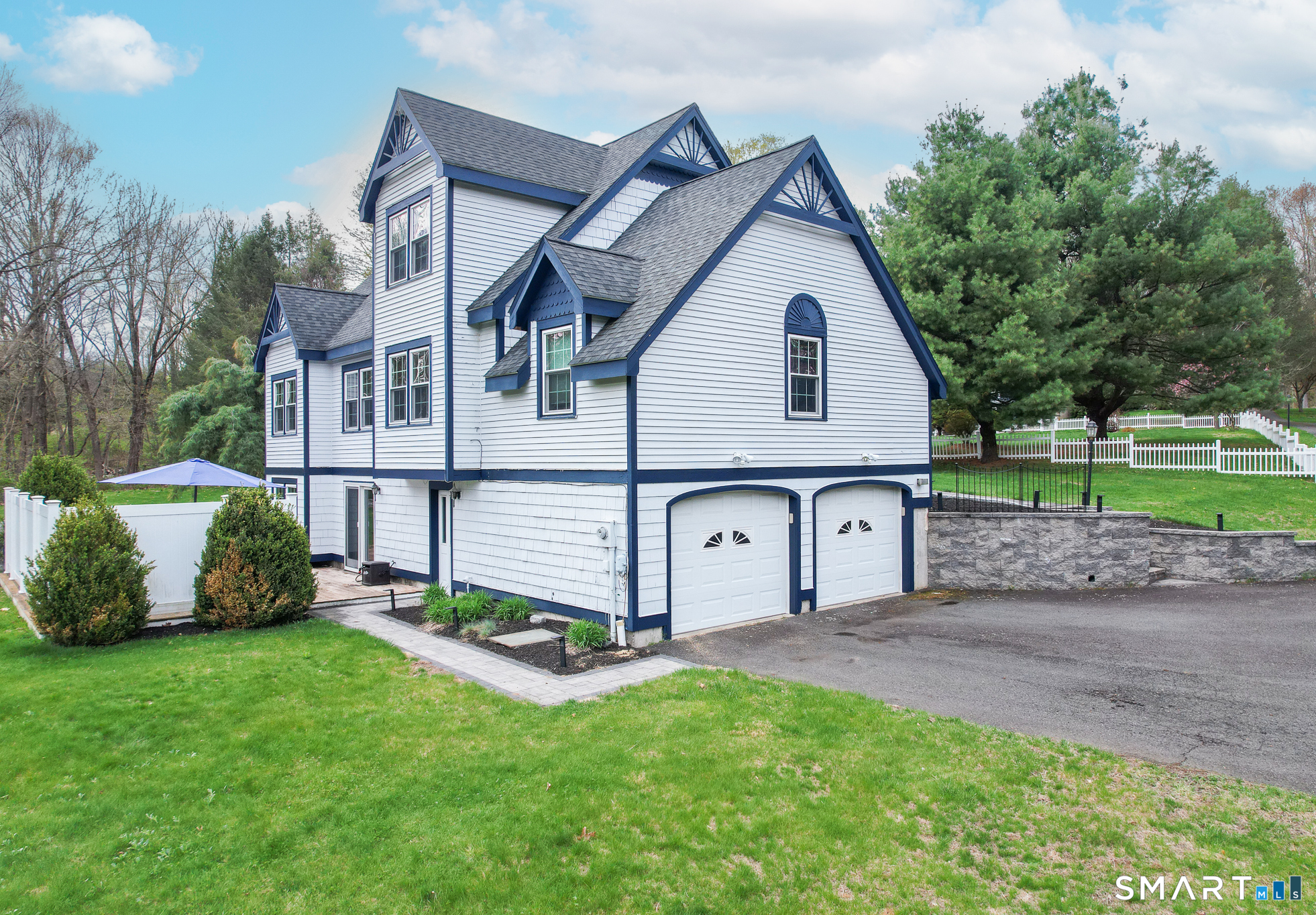 105 Quaker Farms Road Southbury, CT 06488 - Photo 2 of 40 a front view of a house with a garden and yard
