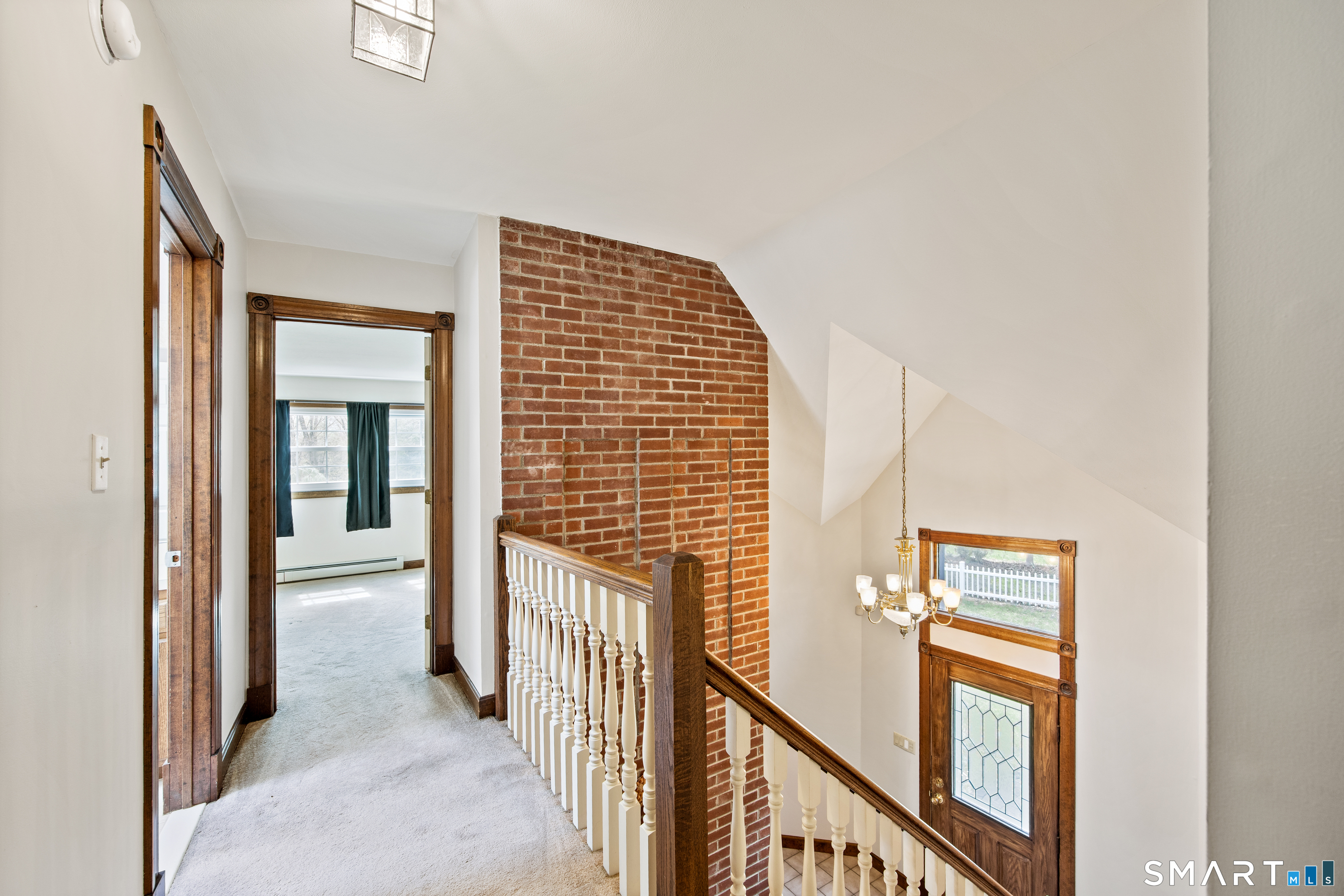 105 Quaker Farms Road Southbury, CT 06488 - Photo 24 of 40 a view of a hallway with wooden floor and windows