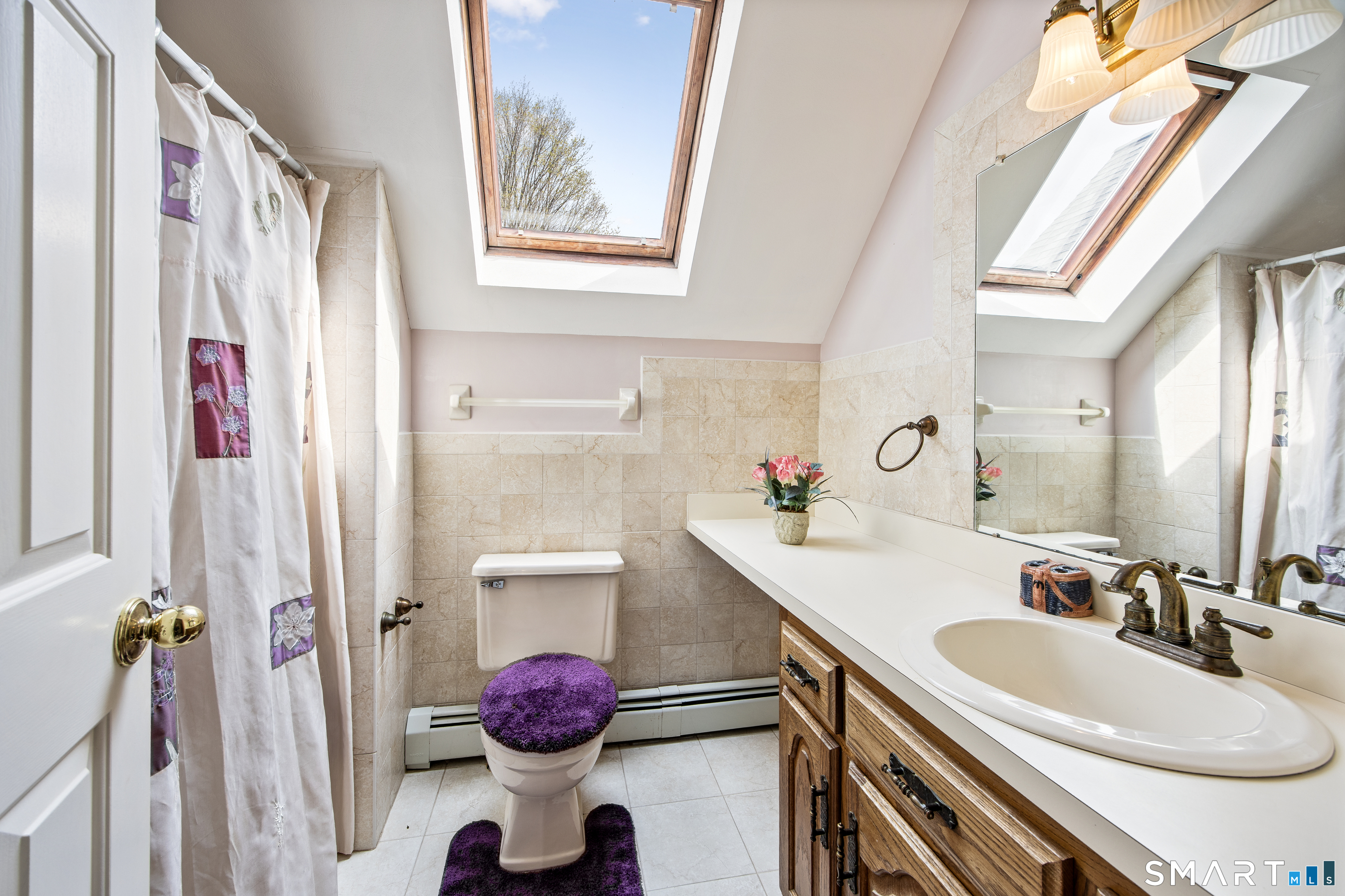 105 Quaker Farms Road Southbury, CT 06488 - Photo 25 of 40 a bathroom with a sink vanity mirror and toilet