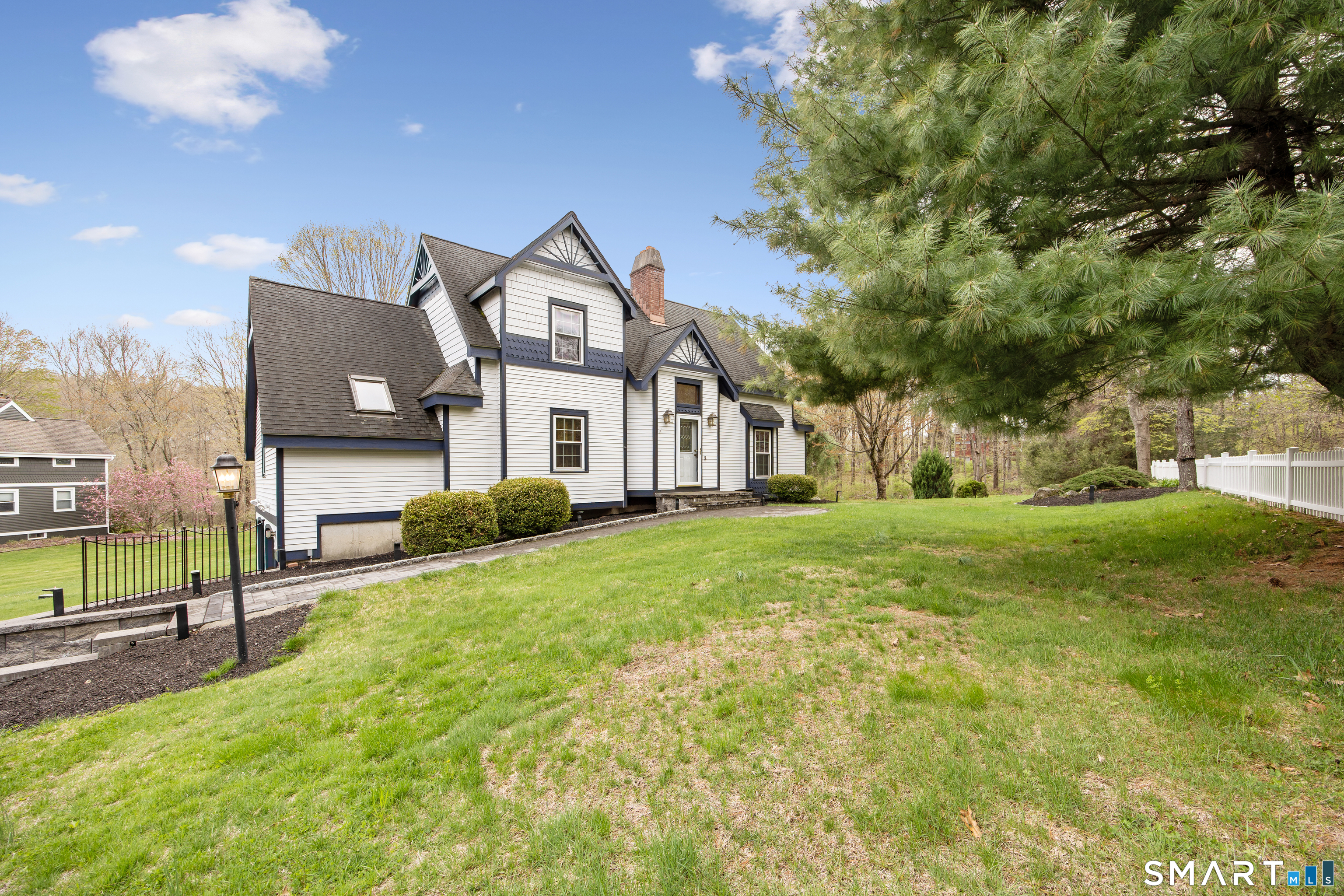 105 Quaker Farms Road Southbury, CT 06488 - Photo 3 of 40 a front view of house with yard and trees