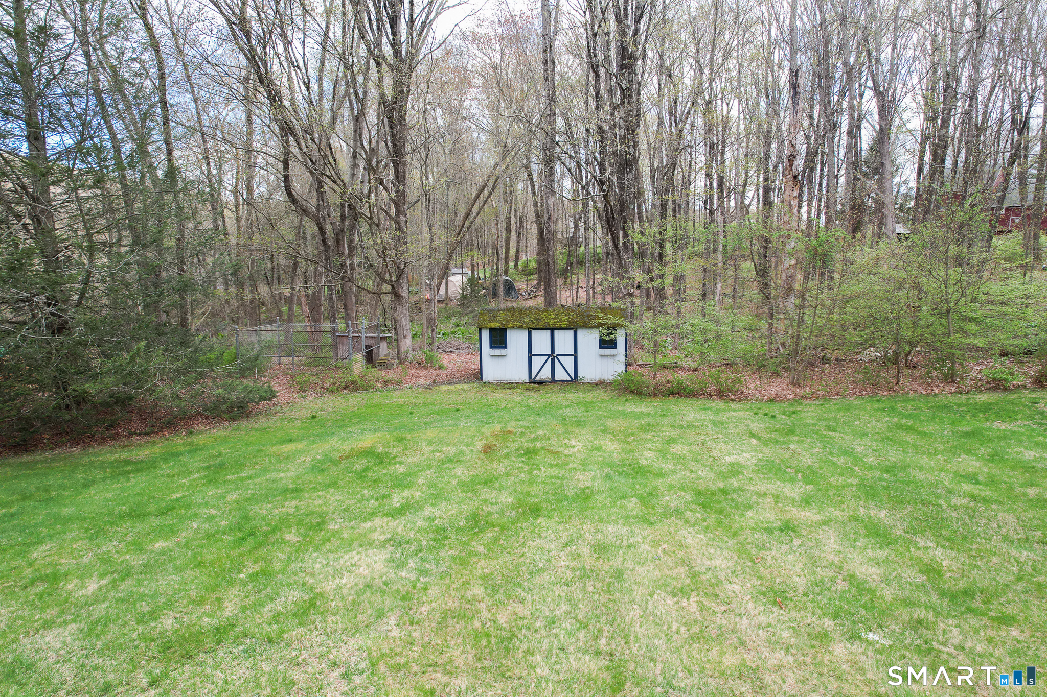 105 Quaker Farms Road Southbury, CT 06488 - Photo 38 of 40 a view of a garden with a bench