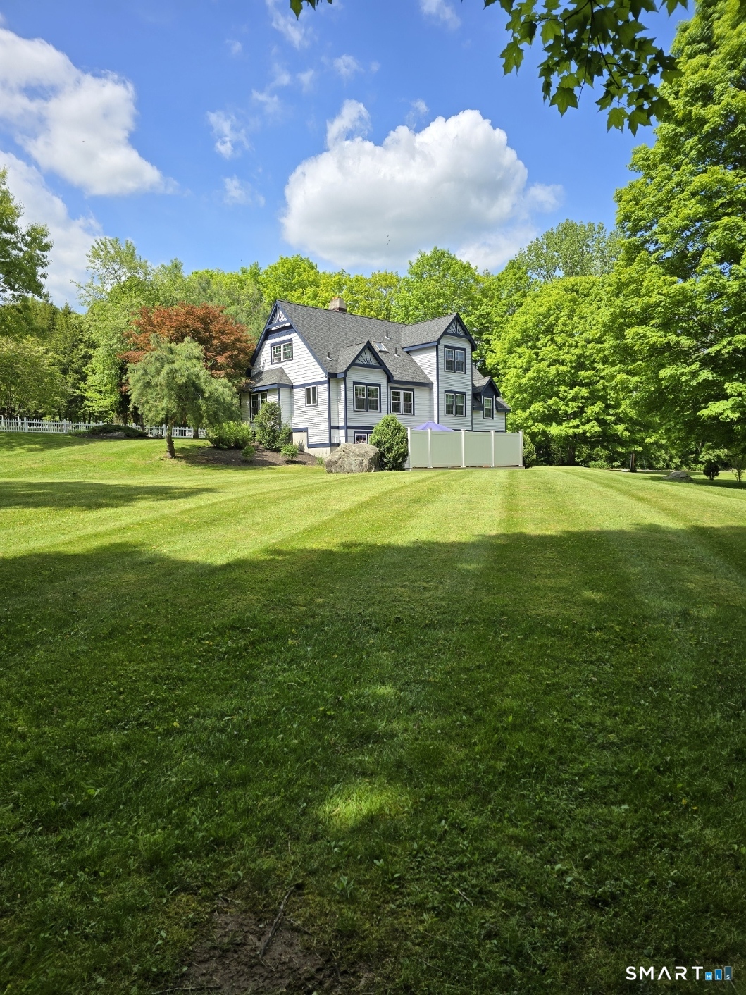 105 Quaker Farms Road Southbury, CT 06488 - Photo 39 of 40 a front view of a house with a big yard