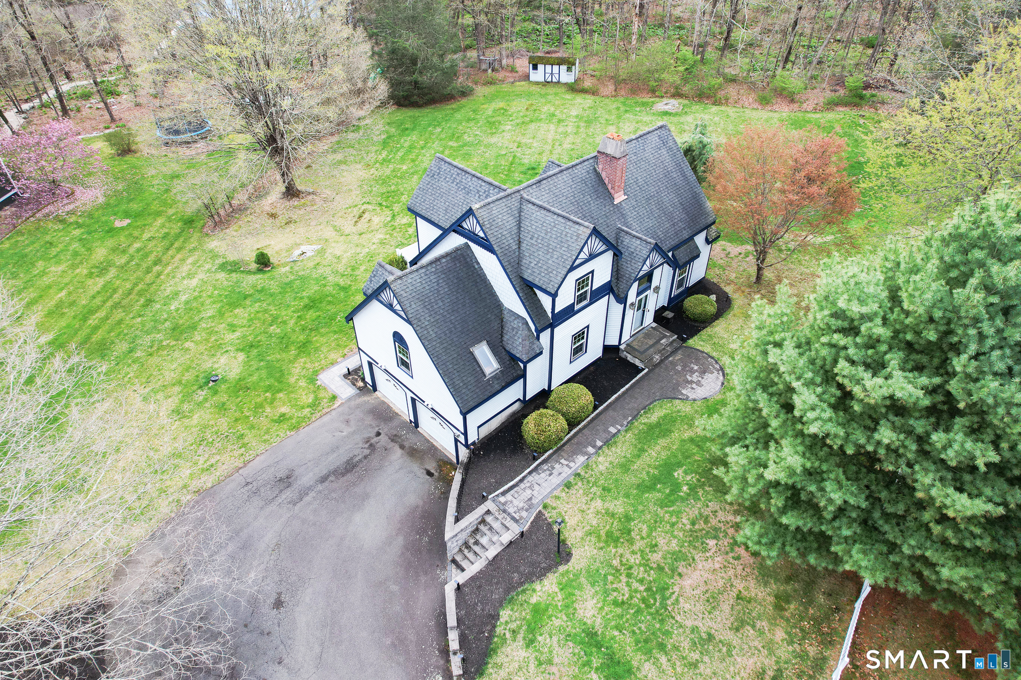 105 Quaker Farms Road Southbury, CT 06488 - Photo 4 of 40 an aerial view of a house with a yard and trees
