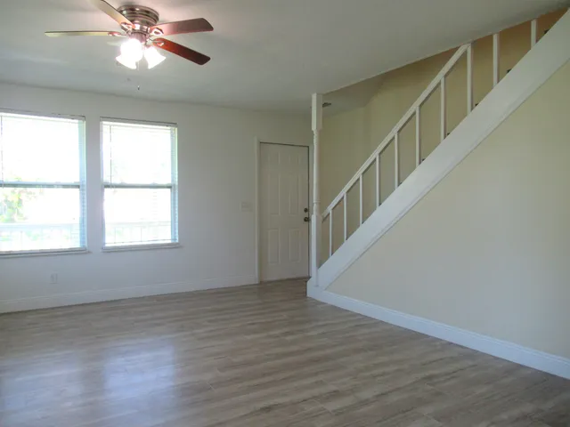 a view of entryway and hall with wooden floor