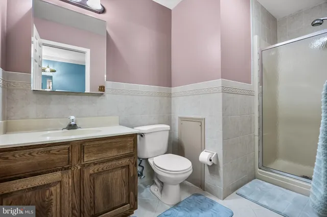 a bathroom with a toilet a sink and mirror