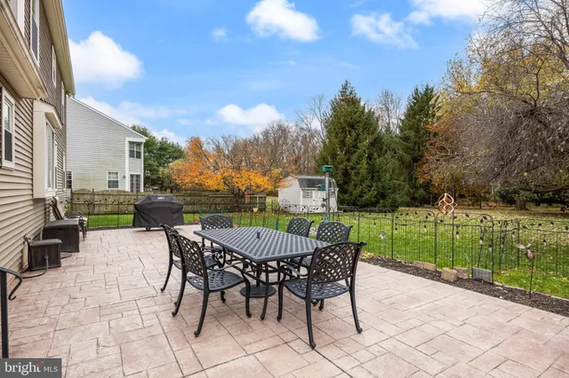 a view of a patio with a table and chairs