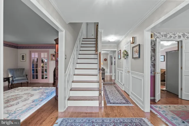 a view of a hallway view with living room and wooden floor