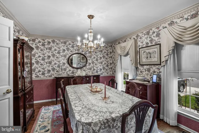 a view of a dining room with furniture and chandelier