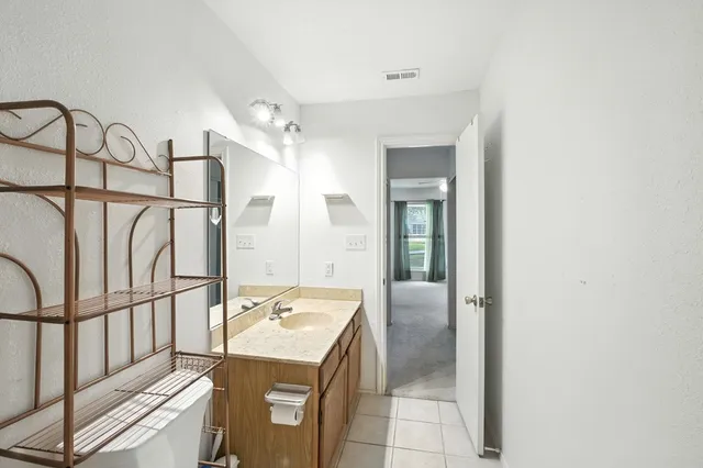 a bathroom with a sink toilet vanity and shower