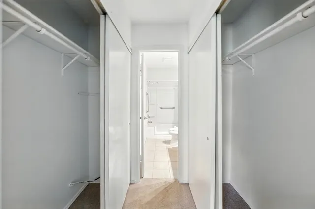 a bathroom with a granite countertop shower and a sink