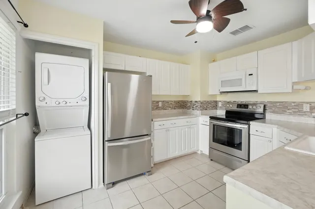 a kitchen with cabinets stainless steel appliances and a counter space